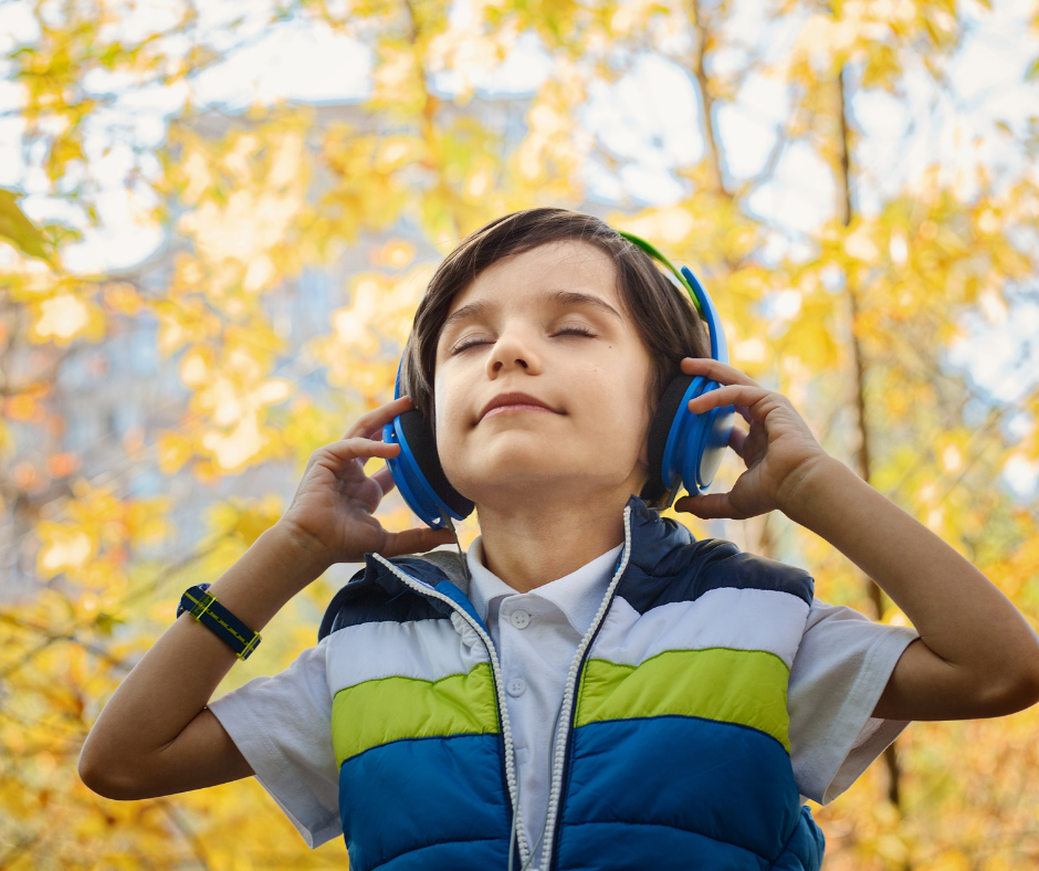 petit garçon qui écoute de la musique dans la nature